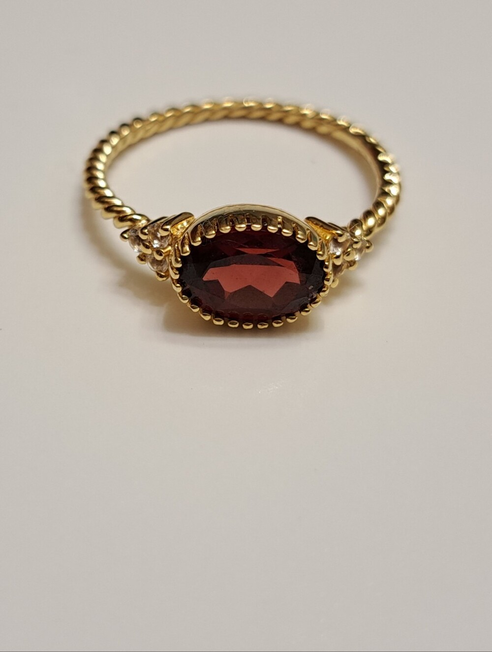 Gold Twist Band Ring with Deep Red Oval Gemstone